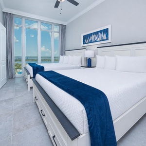 Stretch out on crisp linens in this queen guest suite and enjoy the colors of an evening sunset from the windows