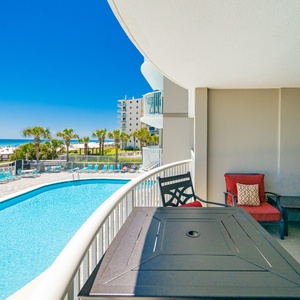 Relax poolside with vibrant beach views and lounge chairs, perfect for soaking up the sun