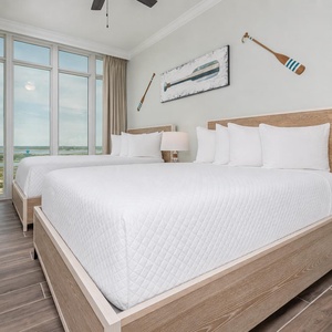 Relax on one of the cozy queen beds in this guest suite and enjoy stunning views