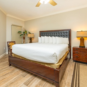 Unwind in this spacious master bedroom featuring a king bed, stylish decor, and warm lighting for a restful retreat