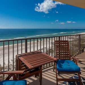 Enjoy the serene beach front view and gentle waves under a clear blue sky