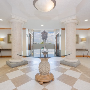 Step into a welcoming lobby with elegant columns and comfortable seating, perfect for relaxing after a day at the beach