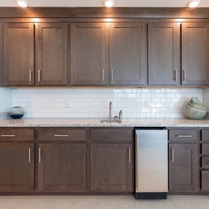 Pour a chilled drink from the stainless mini-fridge with stylish under cabinet lights