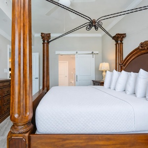 Unwind in this elegant master bedroom after a beach day with your favorite show