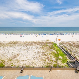 Breathe in the fresh air while enjoying views of the beach and vibrant blue skies from your spacious balcony