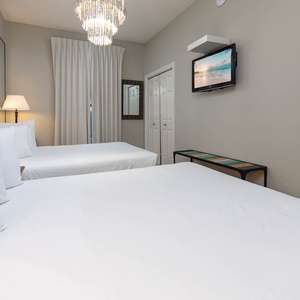 Experience restful nights in this inviting guest room with two queen beds, stylish decor, and a cozy atmosphere