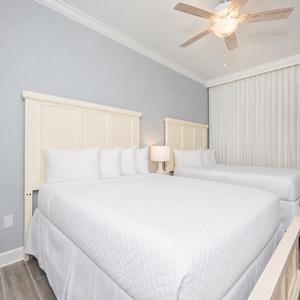 Drift into peaceful sleep on plush queen bedding, surrounded by soft colors and inviting decor in this guest suite