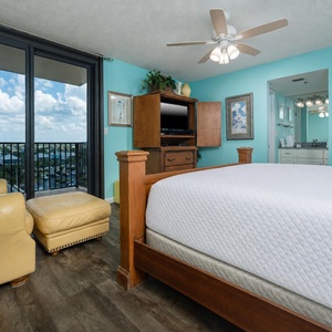 Bright turquoise walls complement the king bed in the master, creating a cheerful atmosphere with a view of the surroundings
