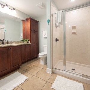 Experience a stylish guest bathroom featuring a spacious vanity, elegant fixtures, and a refreshing walk-in shower
