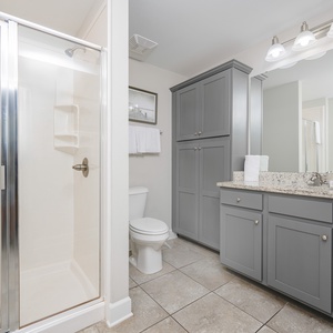 Revitalize your day in this elegant guest bath, embracing the spacious shower and calming ambiance