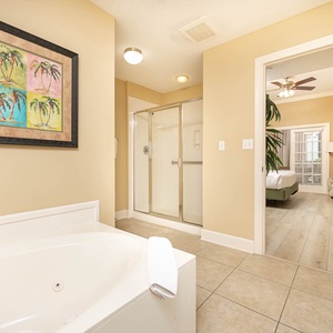 Refresh in the master bath after a day at the beach with a soothing jetted tub and relaxing walk-in shower