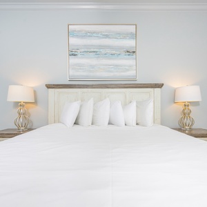 Drift into a peaceful night on the plush king bed in the guest suite, enveloped in soft linens and serene decor