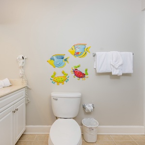 Brighten your day in this cheerful guest bathroom, enjoying convenience and comfort with playful decor around you