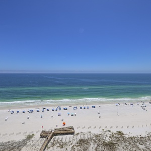 Savor the beach view as rows of umbrellas and chairs line the beach below