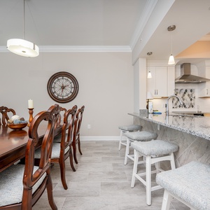 Gather around the elegant dining table or enjoy casual meals at the stylish bar with comfortable seating