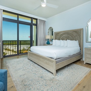 Experience tranquility in the king master suite, resting on plush bedding while enjoying serene views from the balcony