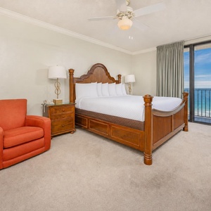 Master suite with a king bed offers serene gulf views through glass doors that fill the room with calm