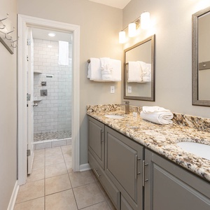 Experience comfort in this stylish master bath featuring a granite countertop, modern fixtures, and a spacious walk-in shower