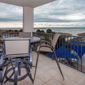 Savor meals on the balcony while enjoying views of the beach and the inviting pool area below