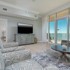 Unwind in the spacious living area, featuring comfortable seating and beachfront balcony access