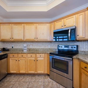 Create delicious meals together in the inviting kitchen, featuring sleek appliances and warm wood accents