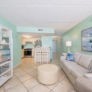 Relax on the sofa with a queen sleeper while enjoying family time and the inviting coastal vibe around you