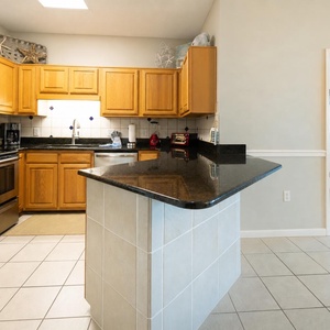 Smooth granite countertops gleam as you prepare snacks in the kitchen before retreating to the master suite