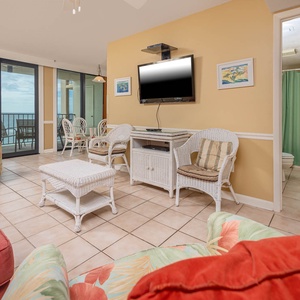 This living area features colorful tropical decor,queen sofa-sleeper, flat-screen TV, and a lovely view of the beach