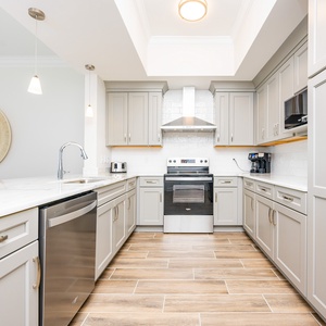 Cook and gather in this stylish kitchen, featuring modern appliances and a spacious countertop for meal preparation