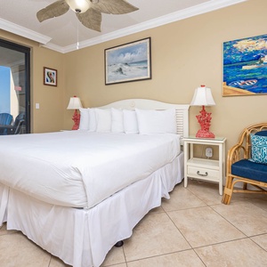 Rest comfortably in the inviting master bedroom featuring a plush king bed, colorful decor, and beachfront balcony access