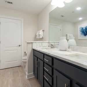 Freshen up at the marbled vanity in the master bath, featuring a soothing tub and walk-in shower