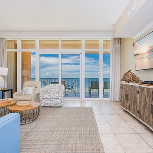 Relax in the inviting living area, featuring comfortable seating, queen sleeper sofa, and beachfront balcony access
