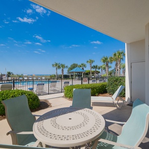 Relax at the outdoor table, enjoying the pool view and gentle breeze while soaking up the sun on your getaway