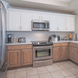 Cook and gather in this modern kitchen featuring stainless appliances, a Keurig and coffee maker
