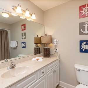 Refresh and rejuvenate in this guest bath, enjoying the coastal decor while preparing for your beach day