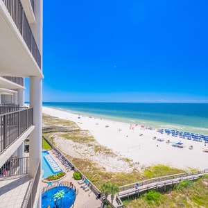 Enjoy marvelous views of the pristine beach and vibrant umbrellas from this inviting balcony retreat