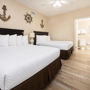 Two double beds in the guest suite offer a cozy spot to rest after a day enjoying the gulf coast