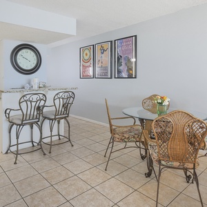 This inviting dining area features a round table with stylish wicker chairs, perfect for enjoying meals together