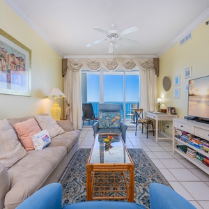 Bright sunlight fills the living room as you settle into soft seating and enjoy the coastal view beyond the glass doors