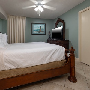This guest bedroom features a plush king bed, a stylish wooden dresser, and a flat-screen TV for your entertainment