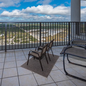 The balcony features two chairs and a stunning view of the state park, perfect for relaxation and enjoying the scenery