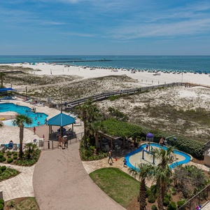 Relax by the pool surrounded by lush landscaping, with easy access to the beach and inviting lounge areas nearby