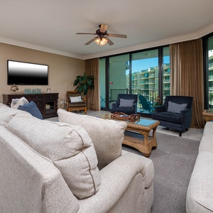 Relax on the cozy sofa with a queen sleeper in this inviting family room with beautiful balcony views