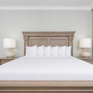 Rest in the serene master bedroom featuring a plush king bed with soft pillows and beach views