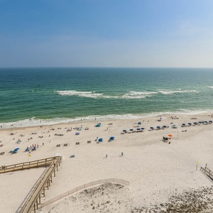 Enjoy breathtaking views of the sandy beach and vibrant umbrellas from your private corner balcony