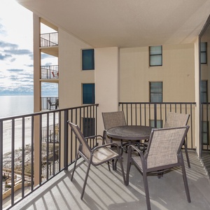 Enjoy breathtaking views from the balcony, featuring a round table and chairs for relaxing moments by the water