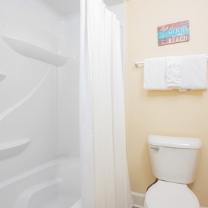 Refresh in the guest bathroom, where fluffy towels await after a day at the beach, enhancing your relaxation