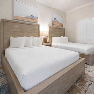 Stylish guest room with two cozy queens and coastal decor for a relaxing retreat