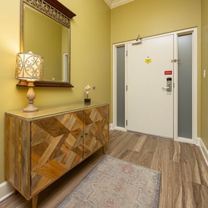 Step into this welcoming entryway, where soft lighting and unique decor set the tone for your beach getaway