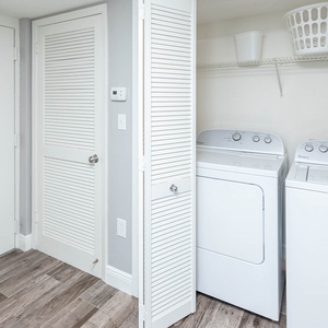 Conveniently access the laundry area with modern appliances and ample storage for a hassle-free stay